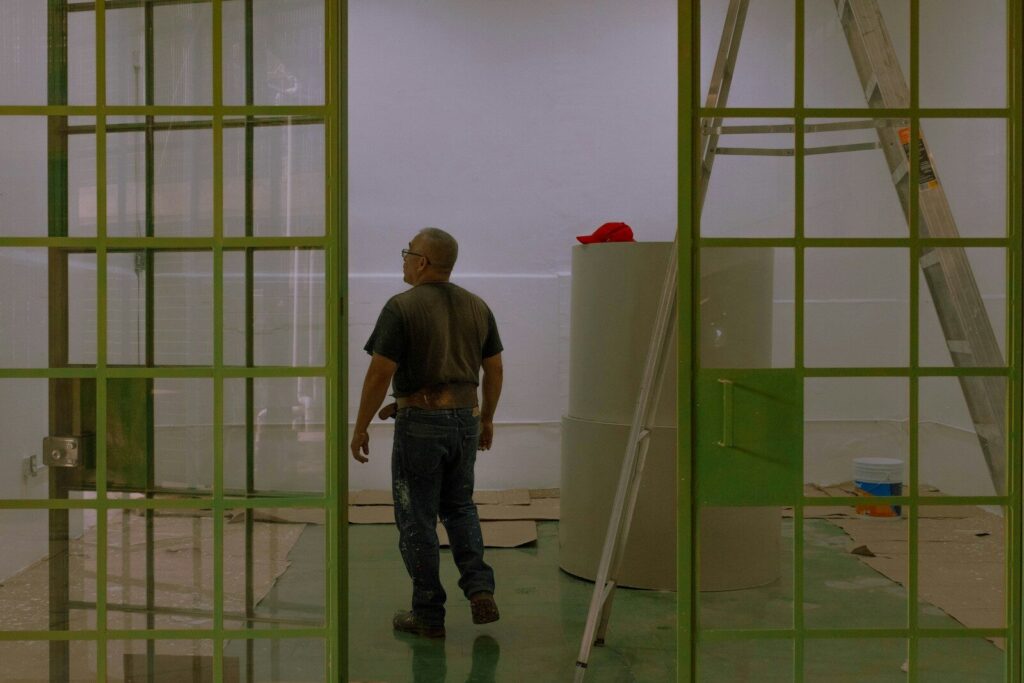 a man standing in a room with a ladder